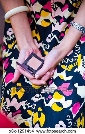 Close-up cropped view of woman holding blush compact View Large Photo Image Picture - Close-up cropped view of woman holding blush compact. Fotosearch