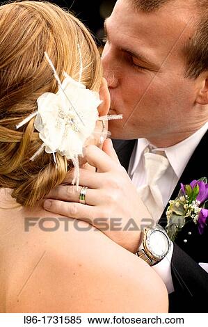 close up image of groom embracing / kissing bride View Large Photo Image Stock Photography - close up image of groom embracing / kissing bride. Fotosearch