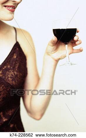 close up image of woman holding glass of red wine View Large Photo Image Stock Image - close up image of woman holding glass of red wine. Fotosearch