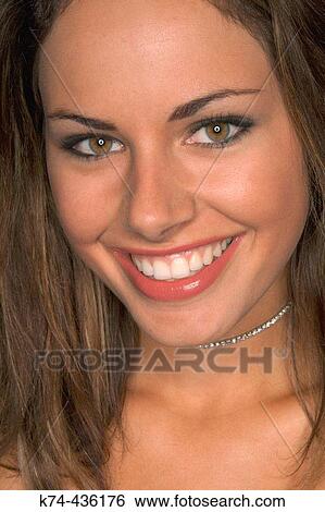 Close-up image of young woman's face View Large Photo Image Stock Photograph - Close-up image of young woman's face. Fotosearch