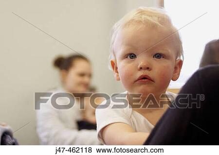 Close up of 18 month old baby boy looking seriously into camera View Large Photo Image Stock Photo - Close up of 18 month old baby boy looking seriously into camera. Fotosearch