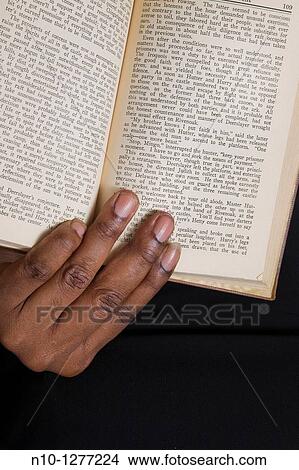 Close-up of a black woman's hand holding a book View Large Photo Image Picture - Close-up of a black woman's hand holding a book. Fotosearch