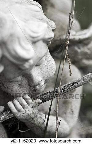 Close up of a cherub in grass View Large Photo Image Stock Image - Close up of a cherub in grass. Fotosearch
