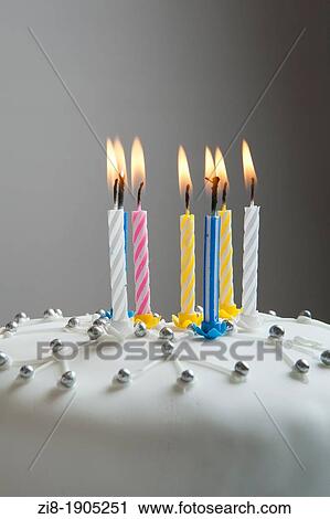 Stock Image - Close-up of a Christmas cake with candles. Fotosearch