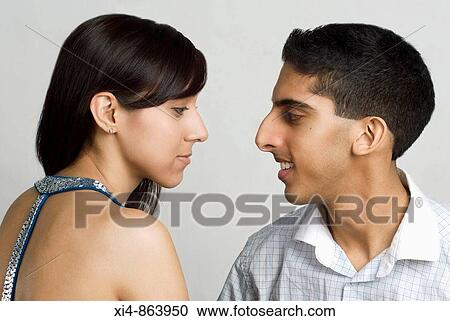 Stock Image - close up of a couple having a conversation Both showing profiles. Fotosearch