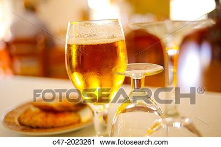 Close up of a glass of cold beer on a restaurant table. View Large Photo Image Stock Image - Close up of a glass of cold beer on a restaurant table.. Fotosearch