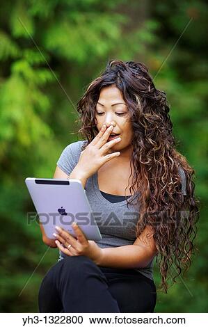 Close up of a happy young woman hand holding an iPad View Large Photo Image Stock Image - Close up of a happy young woman hand holding an iPad. Fotosearch
