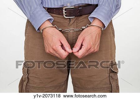 Close-up of a man in handcuffs. View Large Photo Image Stock Photo - Close-up of a man in handcuffs.. Fotosearch
