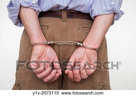 Close-up of a man in handcuffs. View Large Photo Image Stock Photo - Close-up of a man in handcuffs.. Fotosearch