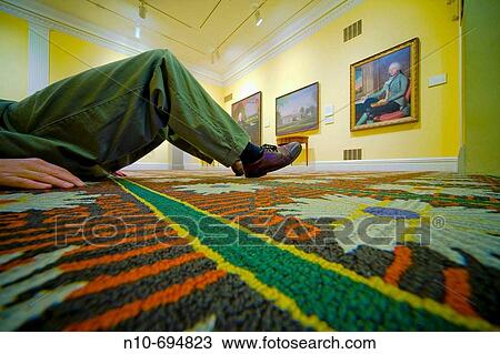 Close-up of a man lying on the floor in a museum View Large Photo Image Stock Image - Close-up of a man lying on the floor in a museum. Fotosearch