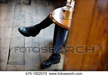 Close-up of a man sitting and resting in a pub, London, England, UK View Large Photo Image Stock Image - Close-up of a man sitting and resting in a pub, London, England, UK. Fotosearch