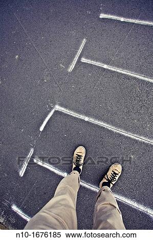 Stock Photography - Close-up of a man standing in a crosswalk. Fotosearch