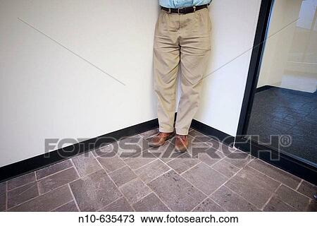 Close-up of a man's legs and feet standing in a corner View Large Photo Image Stock Image - Close-up of a man's legs and feet standing in a corner. Fotosearch