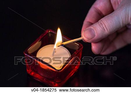 Close up of a person lighting a candle View Large Photo Image Stock Photography - Close up of a person lighting a candle. Fotosearch