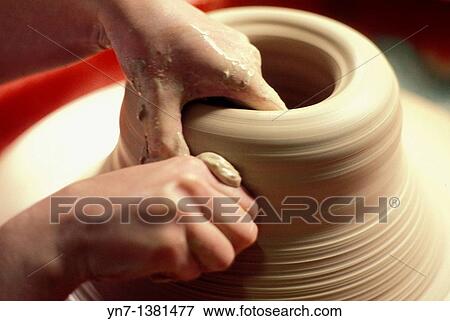 close up of a potter's hands as he carefully shapes his clay on the turning wheel View Large Photo Image Stock Photo - close up of a potter's hands as he carefully shapes his clay on the turning wheel. Fotosearch