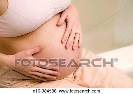 Close-up of a pregnant woman View Large Photo Image Stock Photo - Close-up of a pregnant woman. Fotosearch