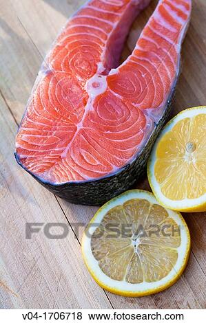 Close up of a raw salmon steak with slices of lemon View Large Photo Image Stock Photo - Close up of a raw salmon steak with slices of lemon. Fotosearch