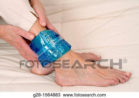 Close up of a Senior woman applying a cold or hot gel compress on her ankle to soothe pain View Large Photo Image Stock Image - Close up of a Senior woman applying a cold or hot gel compress on her ankle to soothe pain. Fotosearch