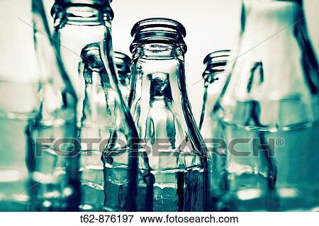 Close-up of a set of empty glass bottles Selective approach View Large Photo Image Stock Photo - Close-up of a set of empty glass bottles Selective approach. Fotosearch