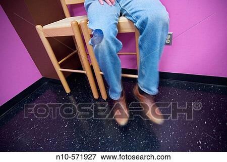 Close-up of a sitting man's legs and feet View Large Photo Image Stock Photo - Close-up of a sitting man's legs and feet. Fotosearch