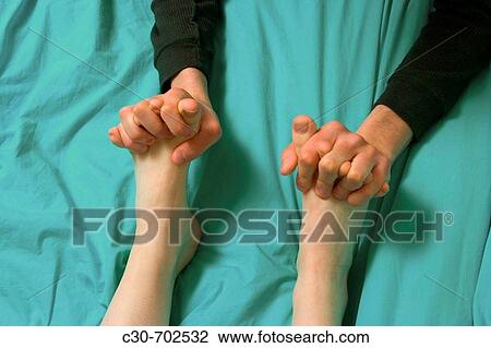 Close-up of a teen boy holding a teen girl's feet in his hands View Large Photo Image Stock Image - Close-up of a teen boy holding a teen girl's feet in his hands. Fotosearch