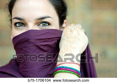 close up of a woman portrait with hands tatto in moroccan henna and hijab View Large Photo Image Picture - close up of a woman portrait with hands tatto in moroccan henna and hijab. Fotosearch