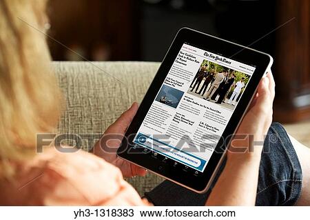 Close up of a woman reading online newspaper New York Times news from an iPad View Large Photo Image Stock Image - Close up of a woman reading online newspaper New York Times news from an iPad. Fotosearch