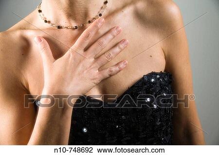 Close-up of a woman wearing an evening gown. View Large Photo Image Stock Image - Close-up of a woman wearing an evening gown.. Fotosearch