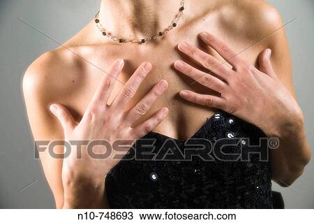 Stock Image - Close-up of a woman wearing an evening gown.. Fotosearch