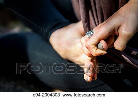 Close up of a woman's hand pulling on her big toe as part of a yoga pose. View Large Photo Image Stock Photo - Close up of a woman's hand pulling on her big toe as part of a yoga pose.. Fotosearch
