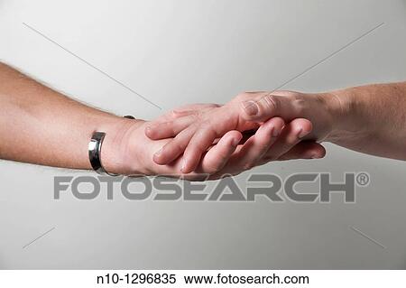 Stock Photography - Close-up of a young couple's hands. Fotosearch