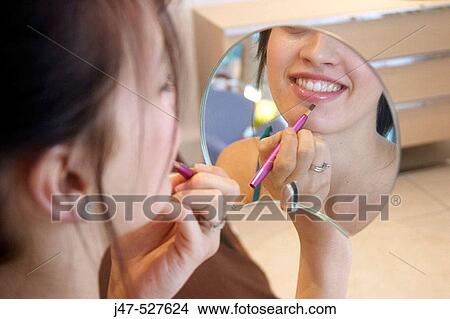 close up of a young girl sitting with mirror and make-up brush View Large Photo Image Picture - close up of a young girl sitting with mirror and make-up brush. Fotosearch