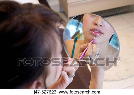 close up of a young girl sitting with mirror and make-up brush View Large Photo Image Stock Image - close up of a young girl sitting with mirror and make-up brush. Fotosearch