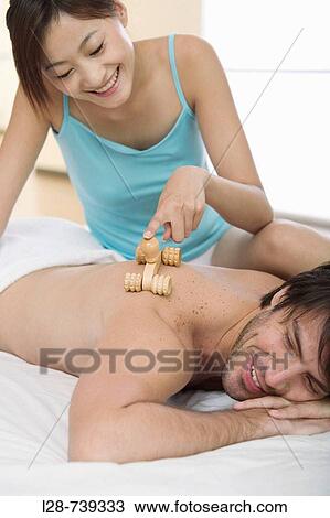 Stock Image - Close-up of a young man massaging a young woman's back. Fotosearch