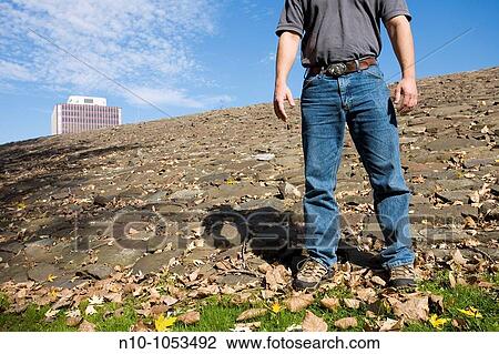 Close-up of a young man standing on a rocky area View Large Photo Image Stock Image - Close-up of a young man standing on a rocky area. Fotosearch