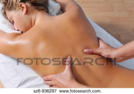 Close up of a young woman getting back massage View Large Photo Image Stock Photo - Close up of a young woman getting back massage. Fotosearch