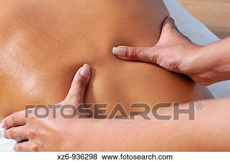 Close up of a young woman getting back massage View Large Photo Image Stock Photo - Close up of a young woman getting back massage. Fotosearch