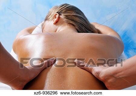 Close up of a young woman getting back massage View Large Photo Image Stock Photograph - Close up of a young woman getting back massage. Fotosearch
