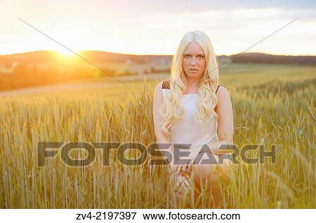 Close-up of a young woman in cornfield at sunset. View Large Photo Image Stock Photo - Close-up of a young woman in cornfield at sunset.. Fotosearch