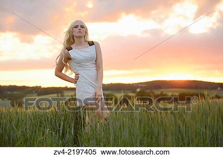 Close-up of a young woman in cornfield at sunset. View Large Photo Image Stock Photography - Close-up of a young woman in cornfield at sunset.. Fotosearch