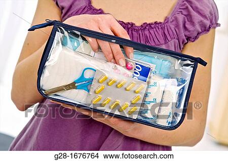 Close up of a Young woman in mauve holding a transparent first aid kit. View Large Photo Image Picture - Close up of a Young woman in mauve holding a transparent first aid kit.. Fotosearch