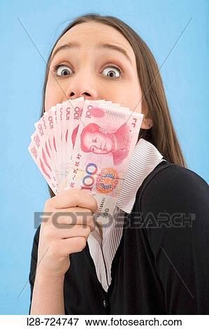 Close-up of a young woman looking at Chinese paper currency View Large Photo Image Stock Photo - Close-up of a young woman looking at Chinese paper currency. Fotosearch