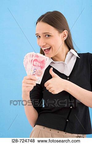 Close-up of a young woman looking at Chinese paper currency, thumbs up, ok signal View Large Photo Image Stock Photo - Close-up of a young woman looking at Chinese paper currency, thumbs up, ok signal. Fotosearch