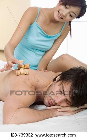 Close-up of a young woman massaging a young man's back View Large Photo Image Stock Image - Close-up of a young woman massaging a young man's back. Fotosearch