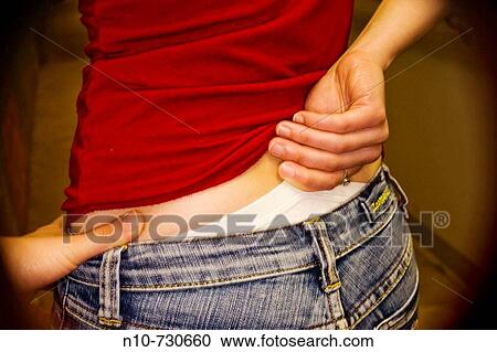Close-up of a young woman pulling up her panties. View Large Photo Image Stock Image - Close-up of a young woman pulling up her panties.. Fotosearch