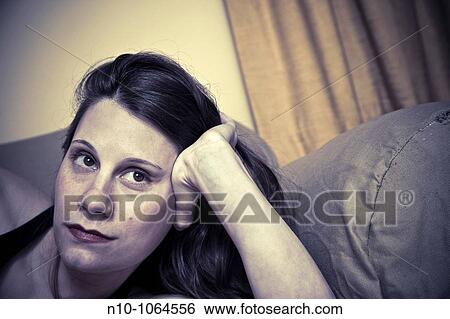 Close-up of a young woman resting View Large Photo Image Stock Photograph - Close-up of a young woman resting. Fotosearch