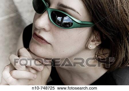 Close-up of a young woman wearing sunglasses. View Large Photo Image Stock Photography - Close-up of a young woman wearing sunglasses.. Fotosearch