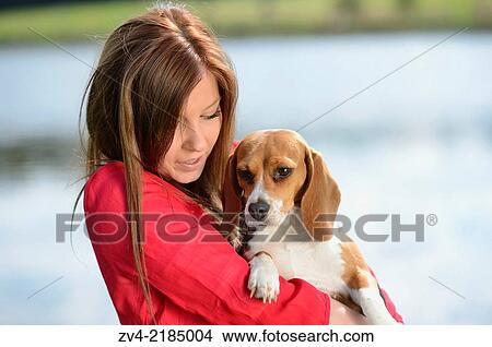 Close-up of a young woman with her Beagle dog in spring. View Large Photo Image Picture - Close-up of a young woman with her Beagle dog in spring.. Fotosearch