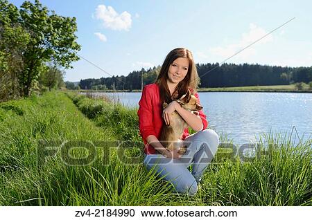 Close-up of a young woman with her Chihuahua dog in spring. View Large Photo Image Stock Image - Close-up of a young woman with her Chihuahua dog in spring.. Fotosearch