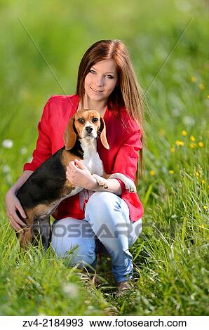 Close-up of a young woman with her Beagle dog in spring. View Large Photo Image Stock Image - Close-up of a young woman with her Beagle dog in spring.. Fotosearch